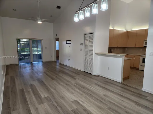 a view of a kitchen with a sink and cabinets