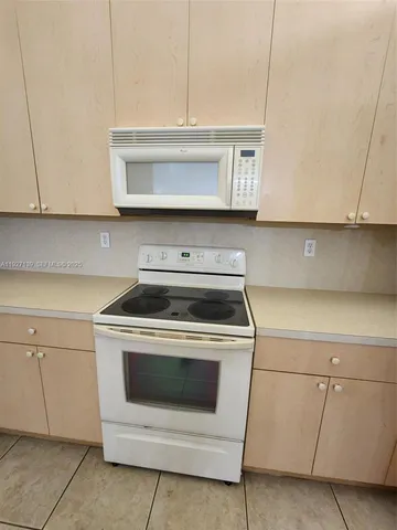 a kitchen with cabinets and appliances