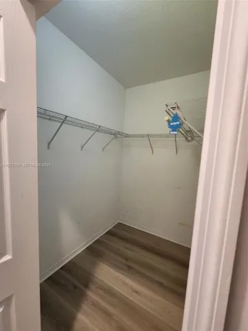 a spacious bathroom with a granite countertop sink and a mirror