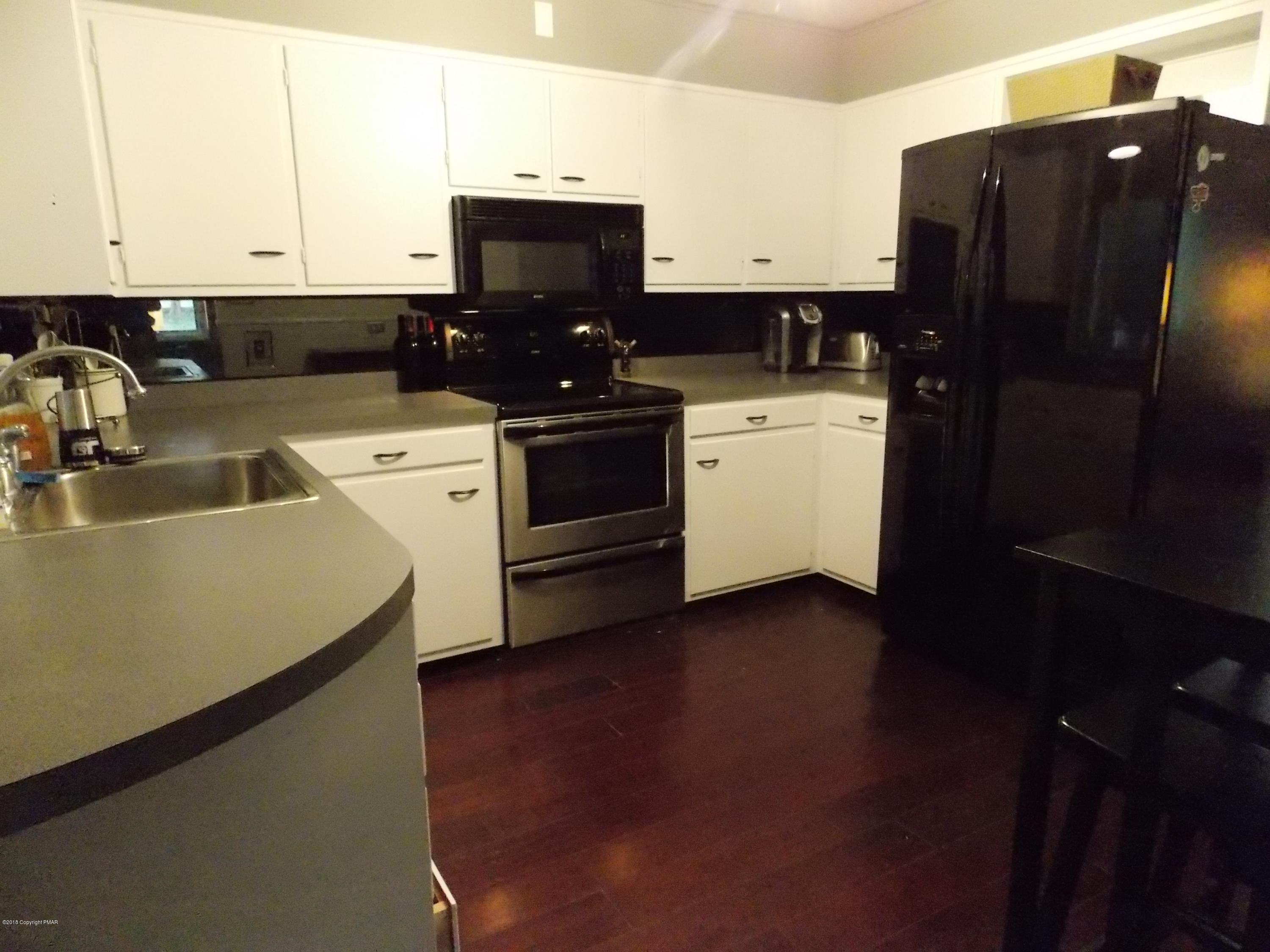 184 Oak Lane Cresco, PA 18326 - Photo 13 of 39 a kitchen with a sink a stove and refrigerator