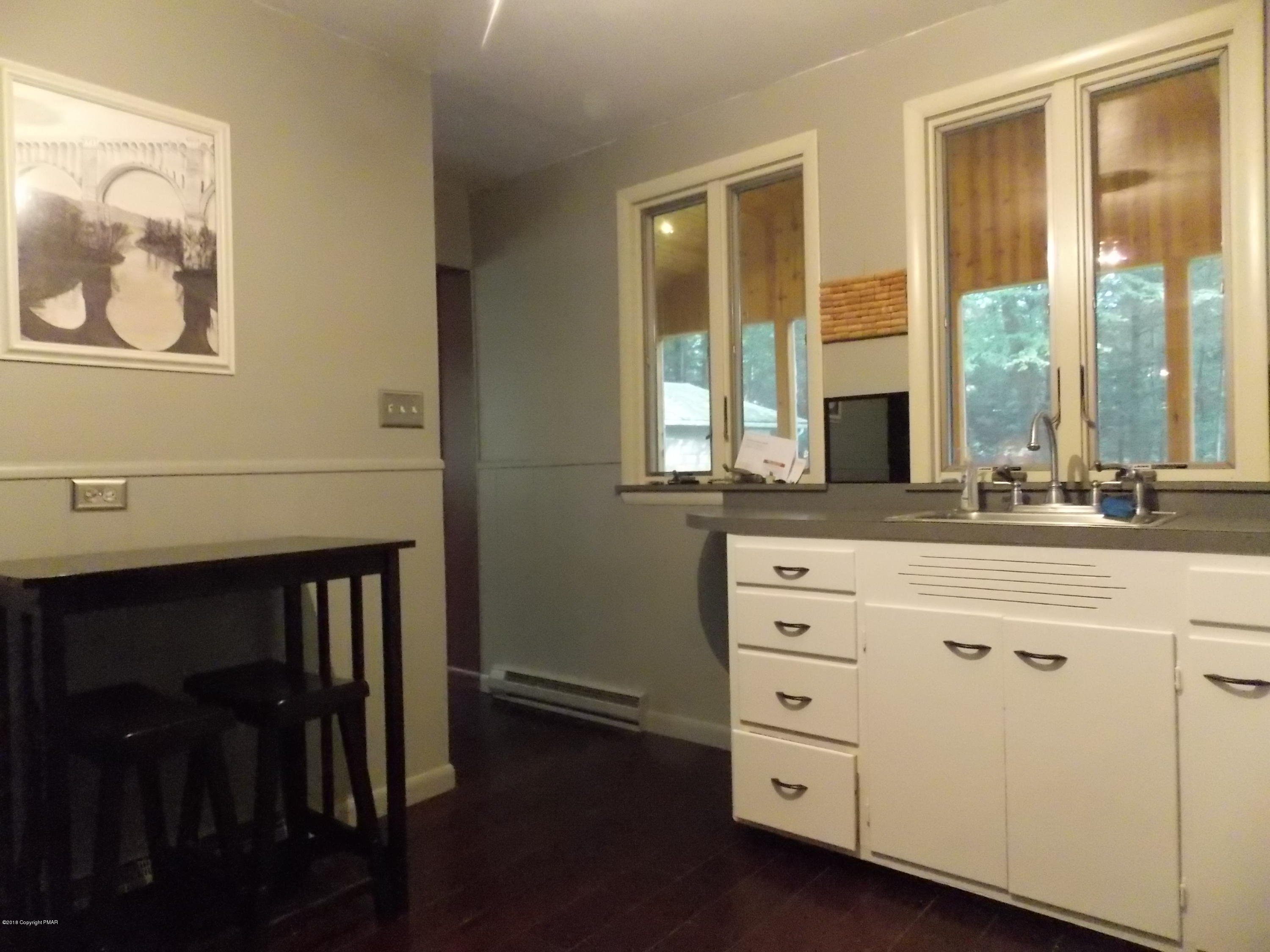 184 Oak Lane Cresco, PA 18326 - Photo 15 of 39 a bathroom with a sink a mirror and a window
