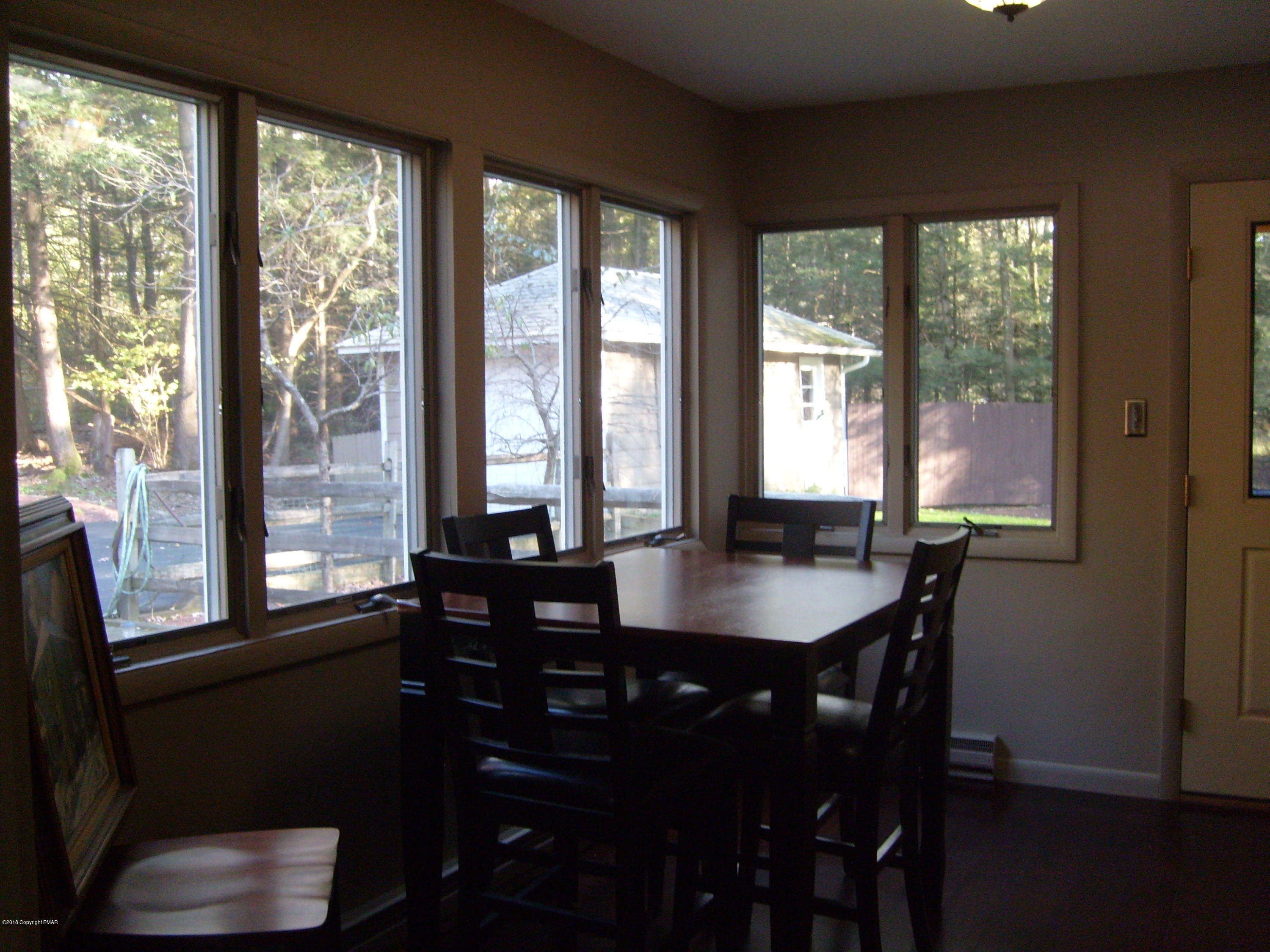184 Oak Lane Cresco, PA 18326 - Photo 10 of 39 a dining room with furniture a chandelier and wooden floor
