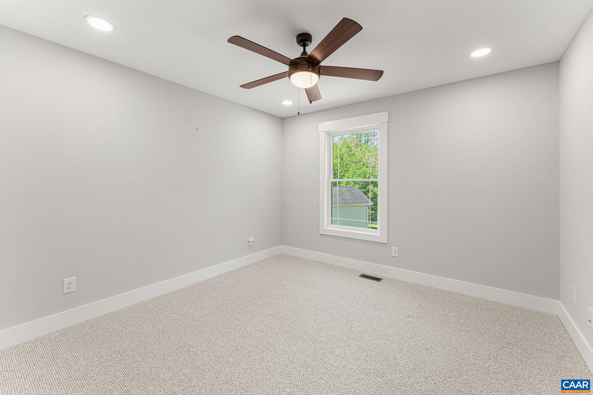 230 Fox Hollow Road Ruckersville, VA 22968 - Photo 32 of 42 an empty room with a window and a ceiling fan