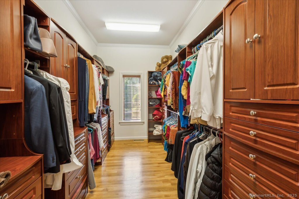 24 Hunting Ridge Drive Simsbury, CT 06070 - Photo 18 of 39 a view of walk in closet with clothes