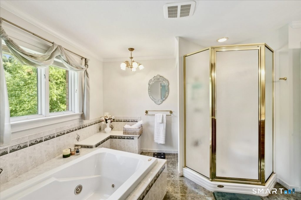 24 Hunting Ridge Drive Simsbury, CT 06070 - Photo 28 of 35 a bathroom with a sink a mirror a bathtub and a shower