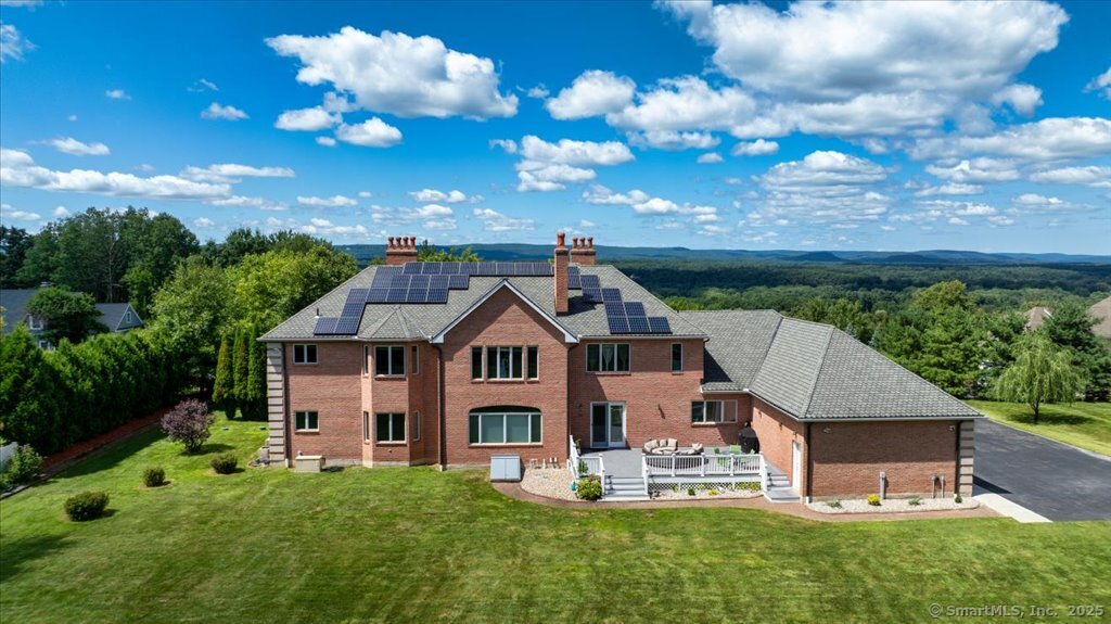 24 Hunting Ridge Drive Simsbury, CT 06070 - Photo 4 of 39 a front view of a house with a yard