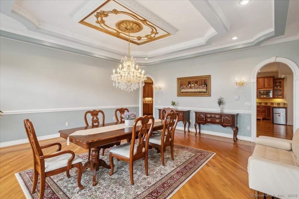 24 Hunting Ridge Drive Simsbury, CT 06070 - Photo 8 of 39 a view of a dining room with furniture a chandelier and wooden floor