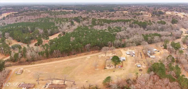an aerial view of mountain with yard