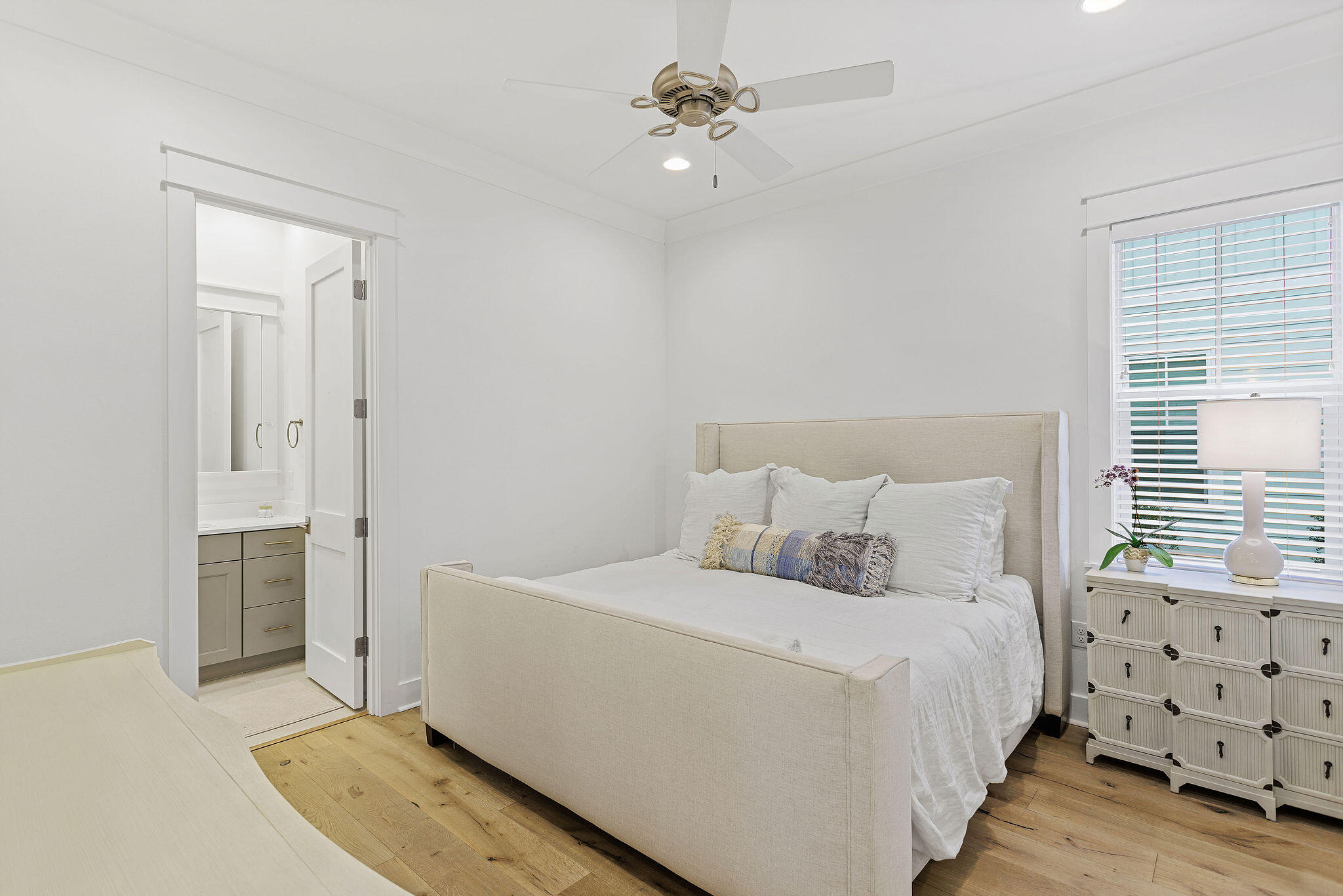 309 Sidecamp Road Watersound, FL 32461 - Photo 15 of 26 a bedroom with a bed and a chandelier fan