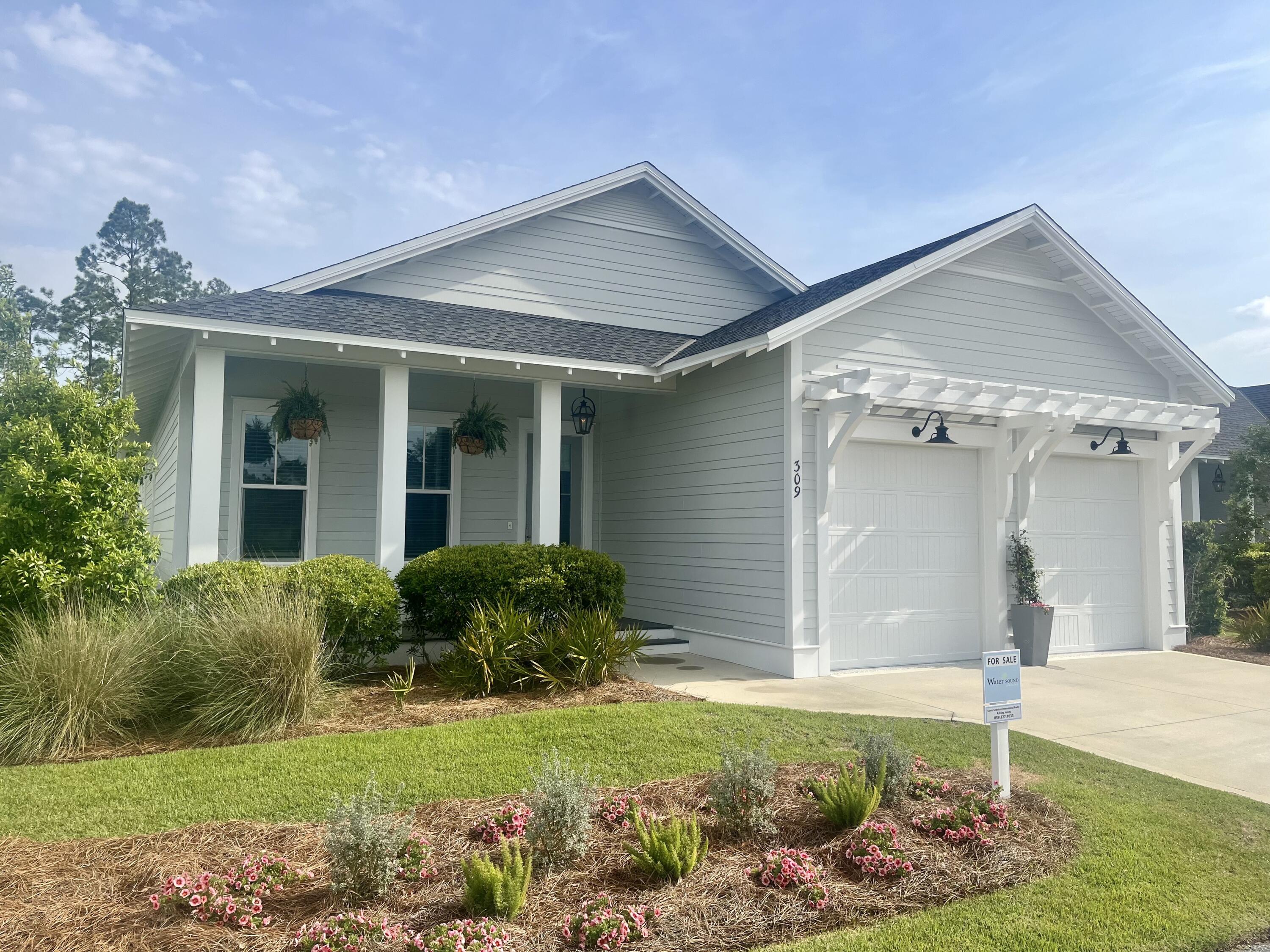 309 Sidecamp Road Watersound, FL 32461 - Photo 2 of 26 a front view of a house with garden