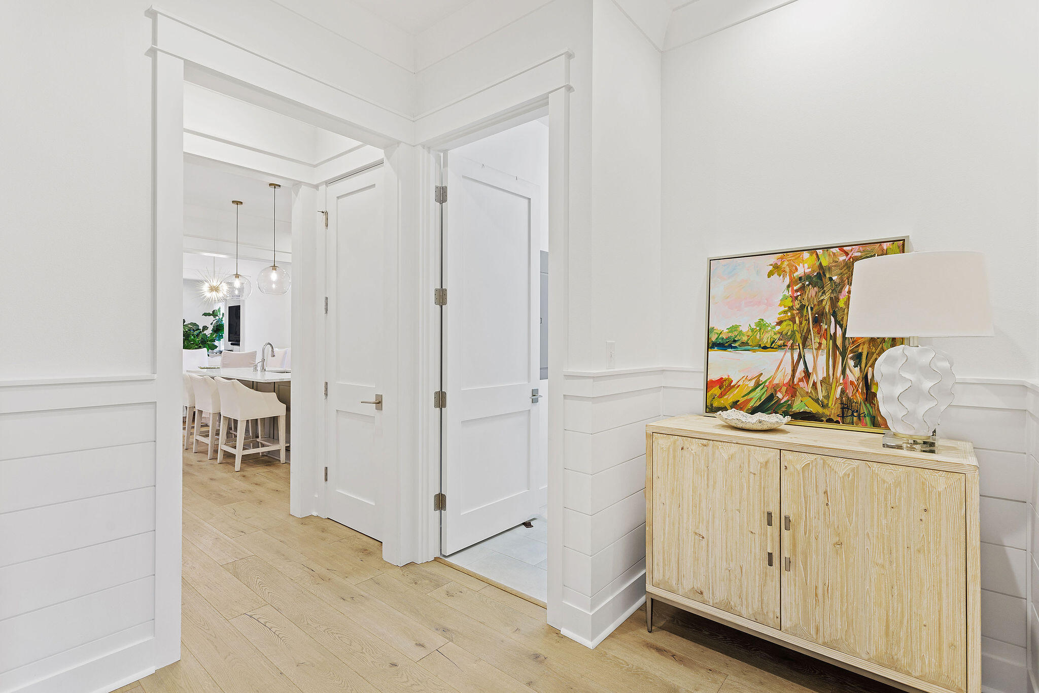 309 Sidecamp Road Watersound, FL 32461 - Photo 4 of 26 a hallway with white cabinets and wooden floor