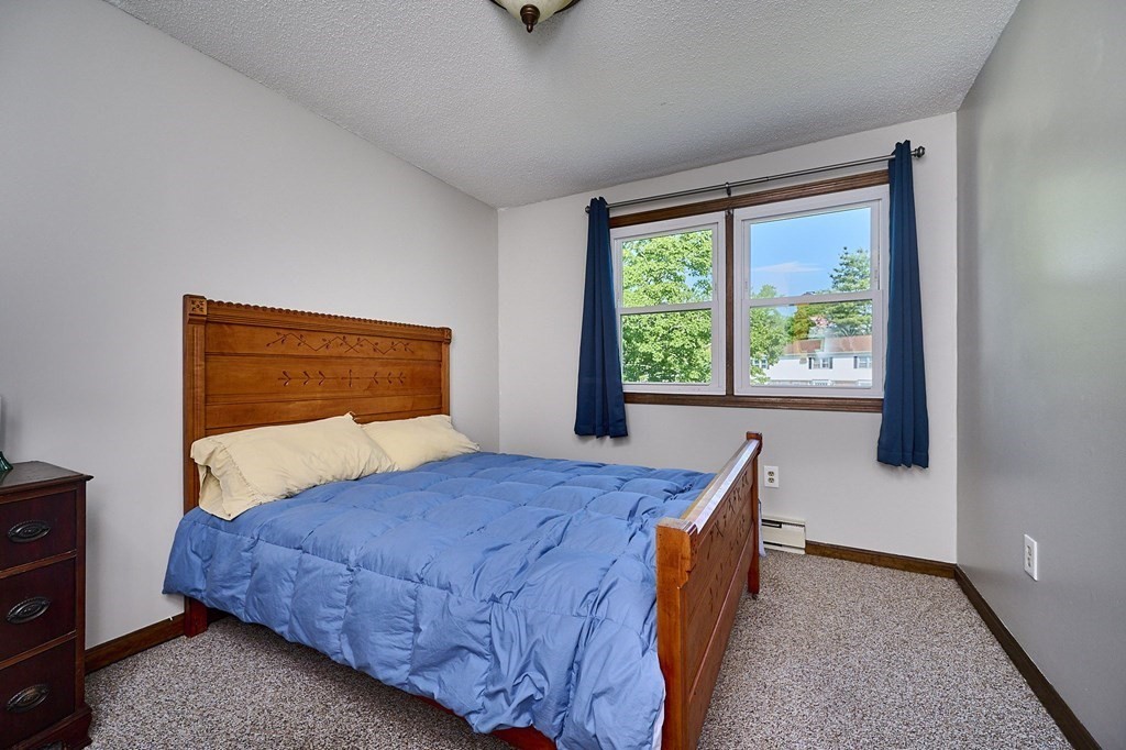 41 South Street, Unit 63 Easthampton, MA 01027 - Photo 14 of 34 a bedroom with a bed and a window