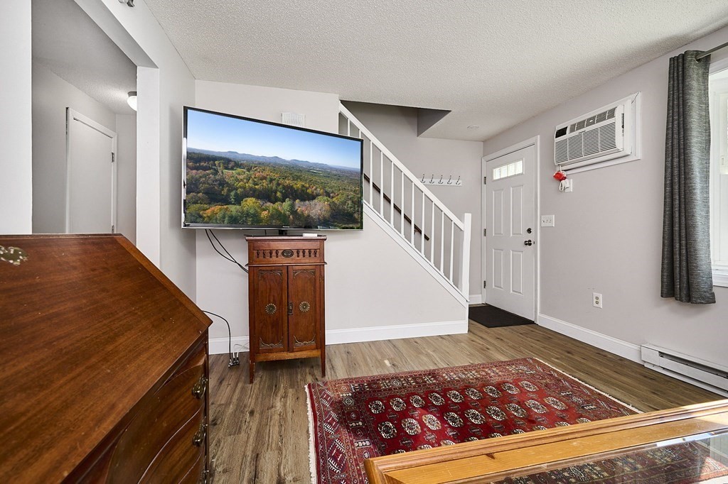 41 South Street, Unit 63 Easthampton, MA 01027 - Photo 7 of 34 a view of a hallway with wooden floor and furniture