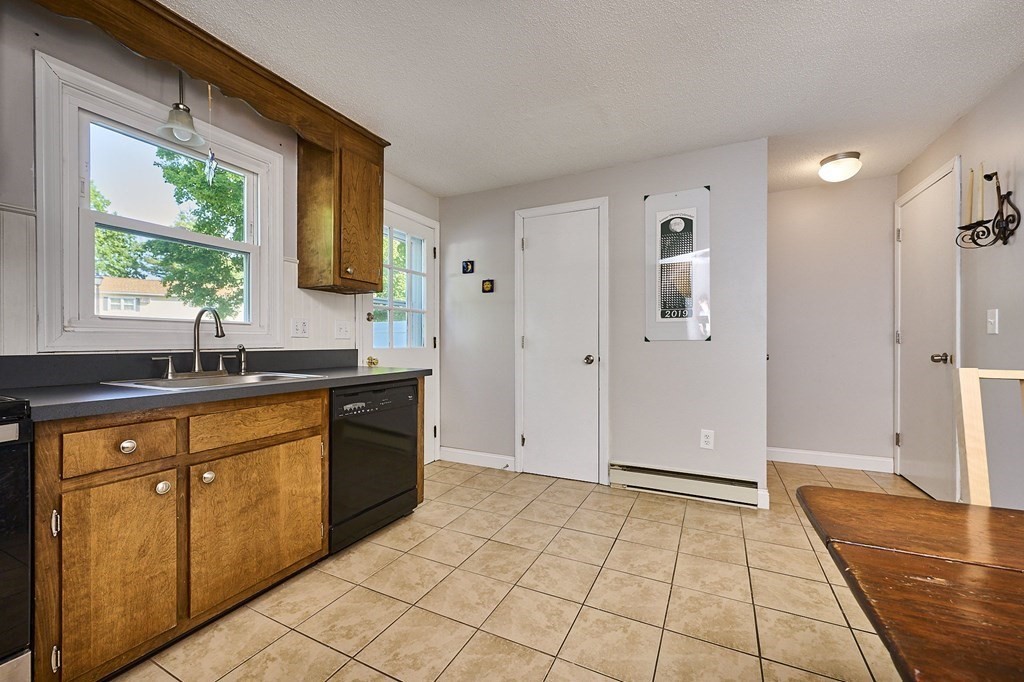 41 South Street, Unit 63 Easthampton, MA 01027 - Photo 9 of 34 a spacious bathroom with a granite countertop sink a mirror and a bathtub