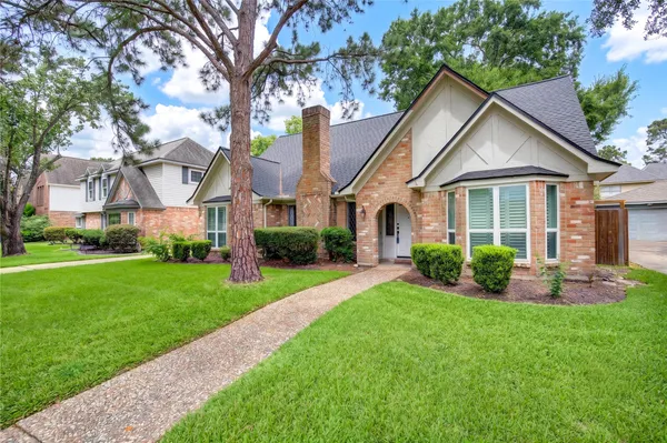 a front view of house with yard and green space