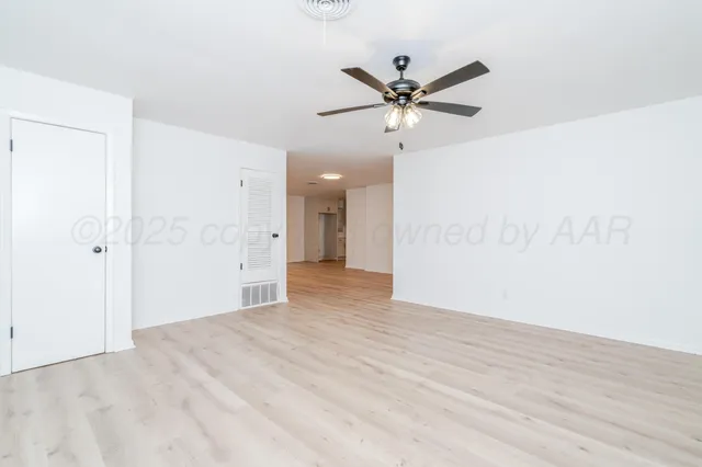 a view of a big room with wooden floor and closet in a kitchen