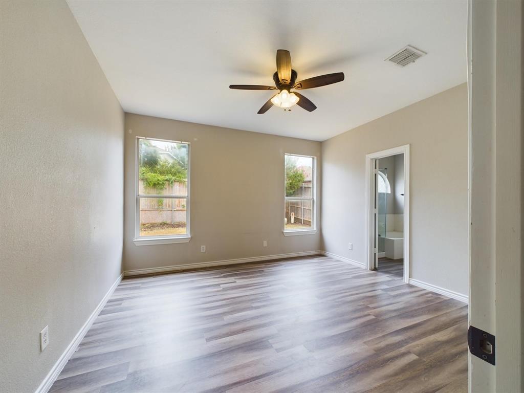 417 Indian Trail Road Roanoke, TX 76262 - Photo 13 of 19 a view of empty room with wooden floor and fan