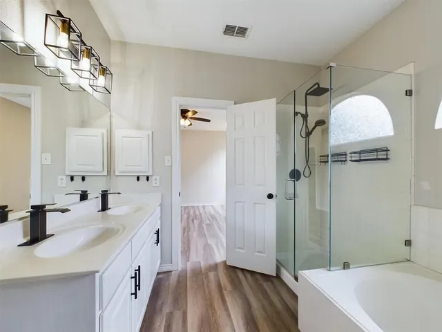 a bathroom with a double vanity sink and mirror
