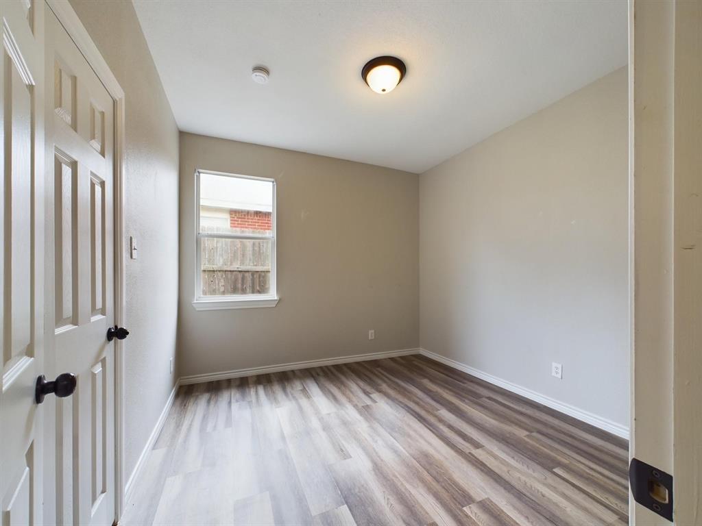 417 Indian Trail Road Roanoke, TX 76262 - Photo 17 of 19 a view of a room with wooden floor and a window