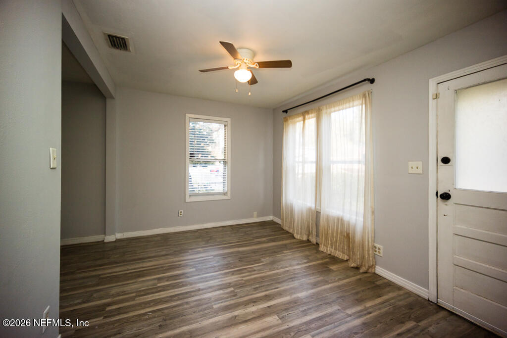 8034 Gordean Road Jacksonville, FL 32221 - Photo 19 of 37 a view of an empty room with wooden floor and a window