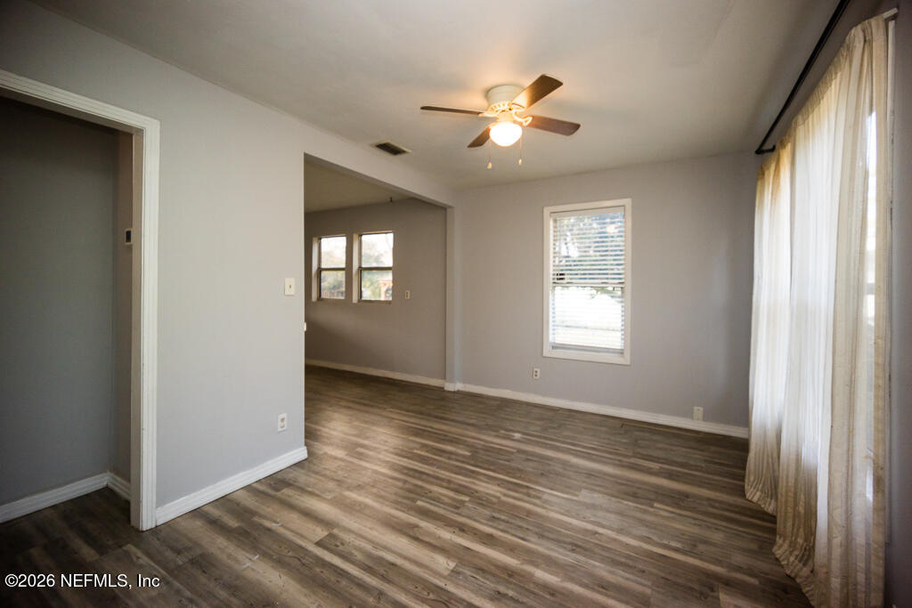 8034 Gordean Road Jacksonville, FL 32221 - Photo 20 of 37 a view of an empty room with wooden floor and a window