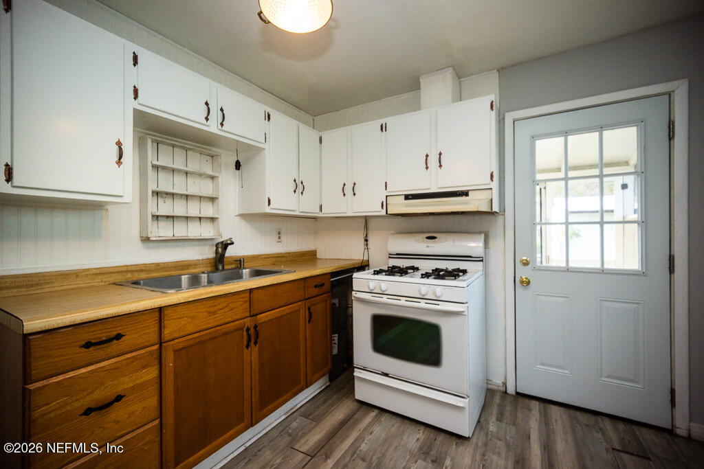 8034 Gordean Road Jacksonville, FL 32221 - Photo 22 of 37 a kitchen with cabinets appliances a sink and a window