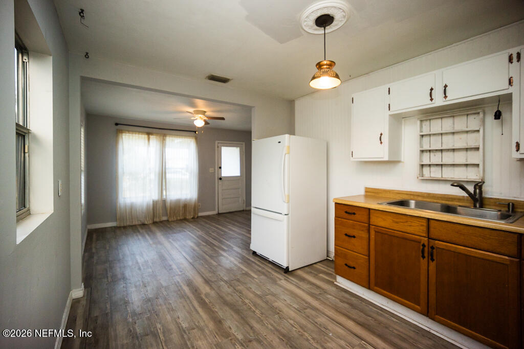 8034 Gordean Road Jacksonville, FL 32221 - Photo 23 of 37 a kitchen with refrigerator a stove a sink and cabinets