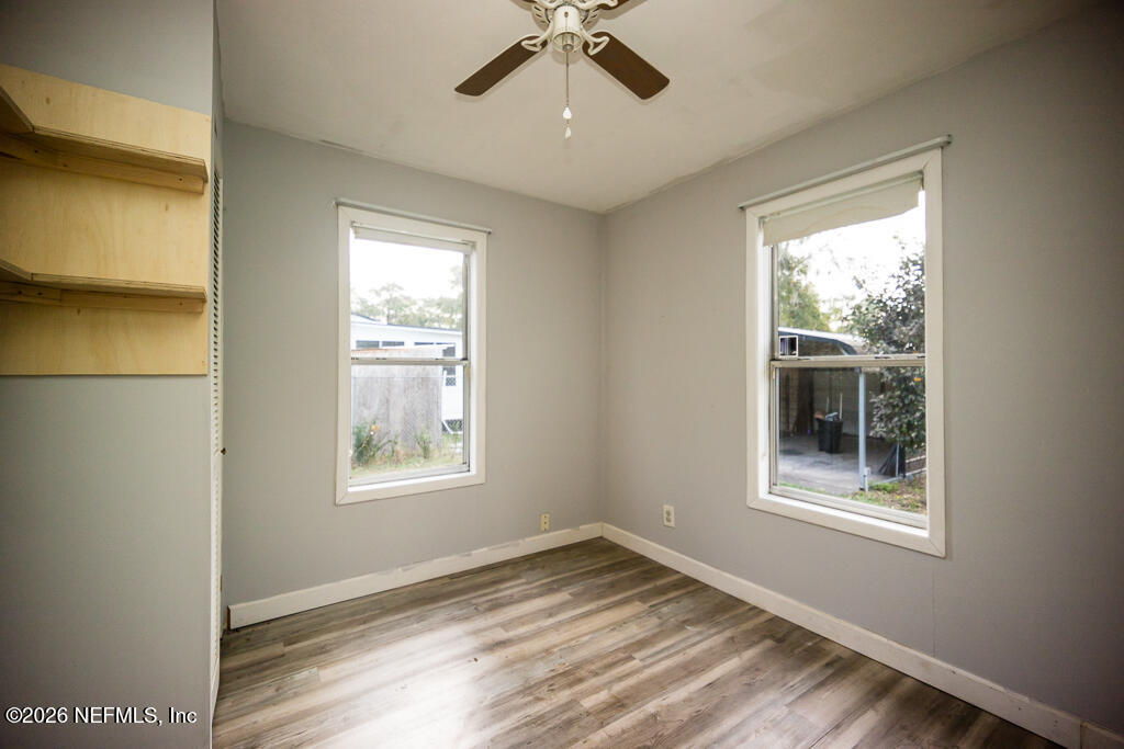 8034 Gordean Road Jacksonville, FL 32221 - Photo 24 of 37 a view of an empty room with a window and wooden floor