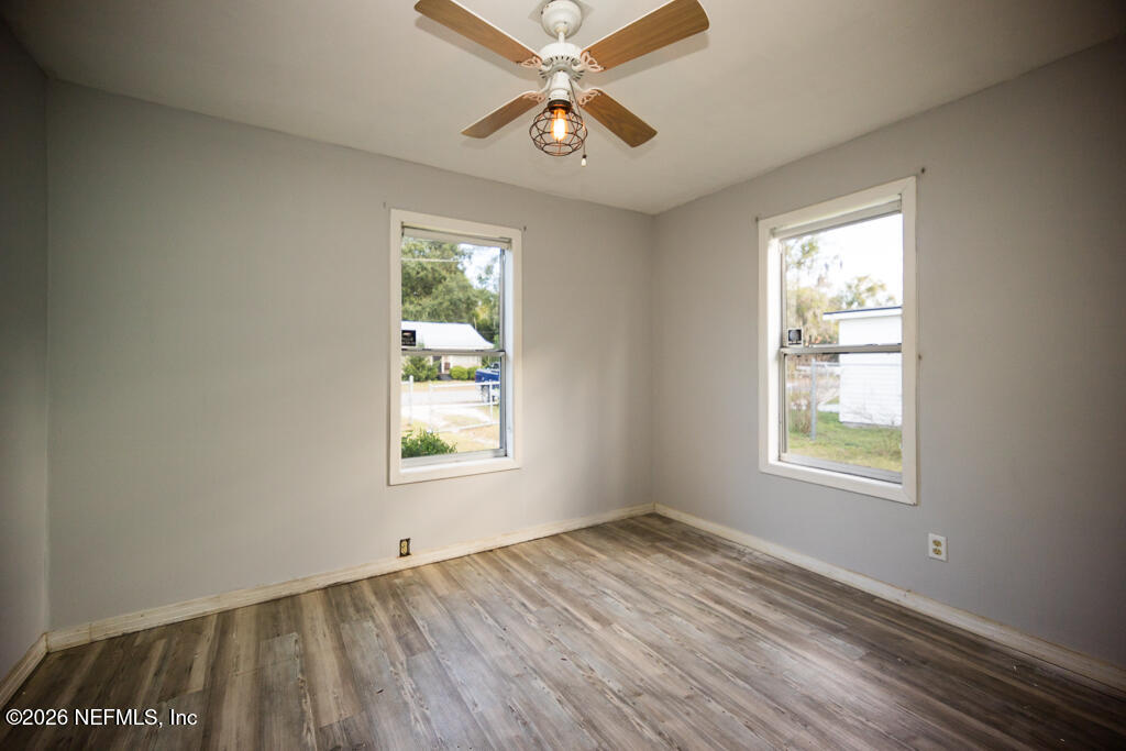 8034 Gordean Road Jacksonville, FL 32221 - Photo 26 of 37 a view of an empty room and window and chandelier fan