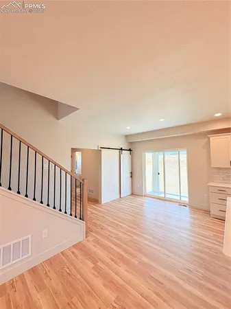 a view of a room with wooden floor and fence