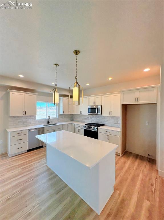 810 Keystone Loop Canon City, CO 81212 - Photo 2 of 13 a large kitchen with stainless steel appliances a large counter top a stove a sink dishwasher and a refrigerator