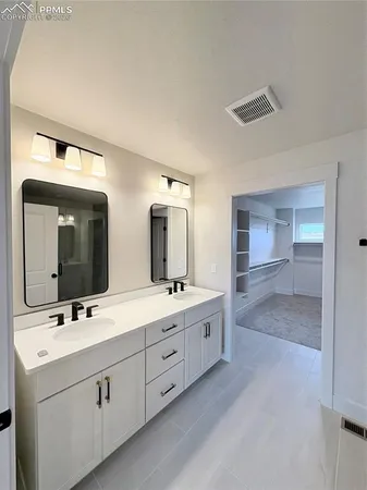 a bathroom with a double vanity sink and mirror