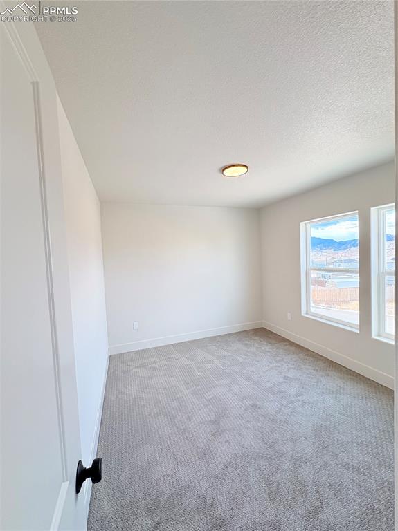 810 Keystone Loop Canon City, CO 81212 - Photo 9 of 13 an empty room with windows