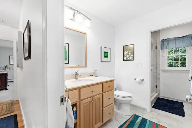 a kitchen with stainless steel appliances a refrigerator and a book shelf