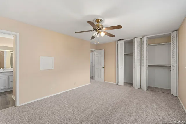 a view of a big room with chandelier fan and a cabinet