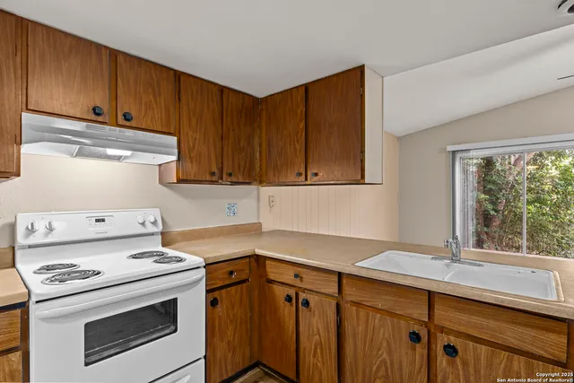 a kitchen with a stove and a sink