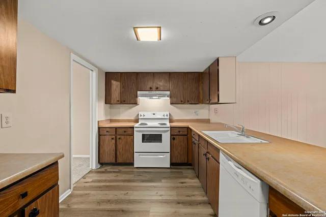 a kitchen with a sink stove and cabinets