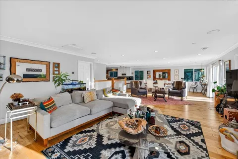 a living room with furniture a rug and a window