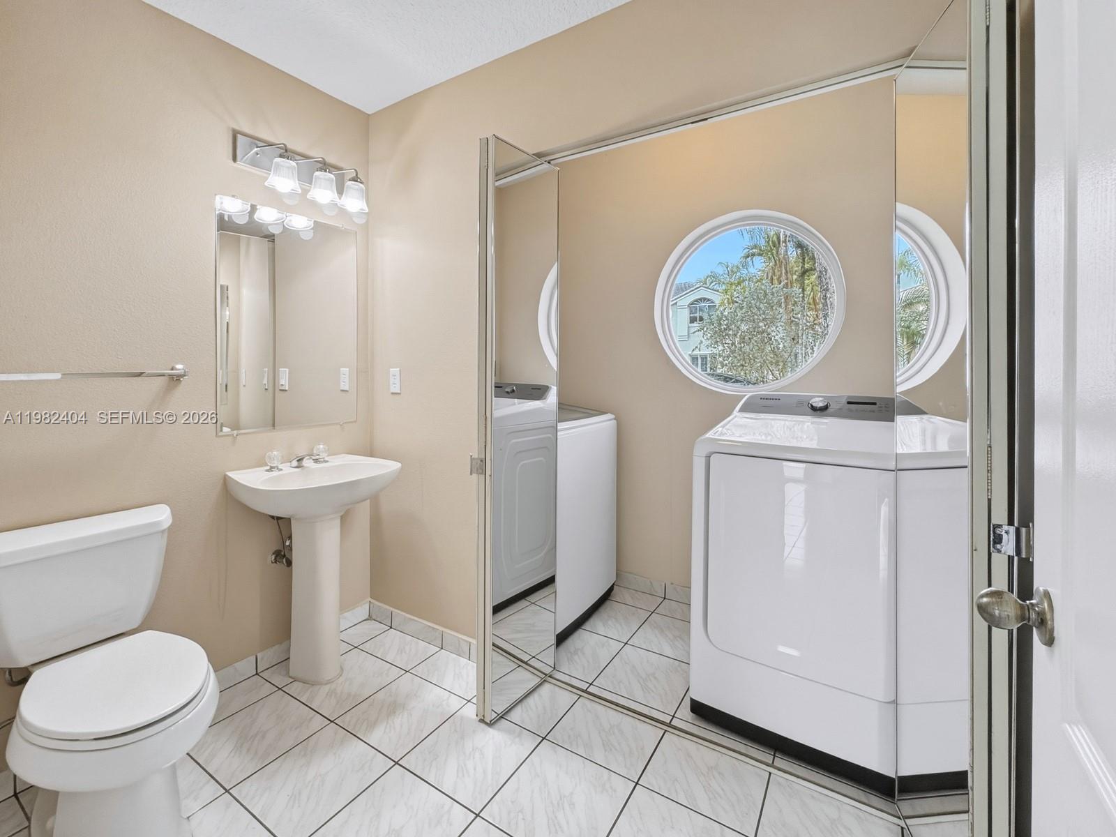2640 Rampart Way North Cooper City, FL 33026 - Photo 20 of 58 a bathroom with a toilet sink and mirror