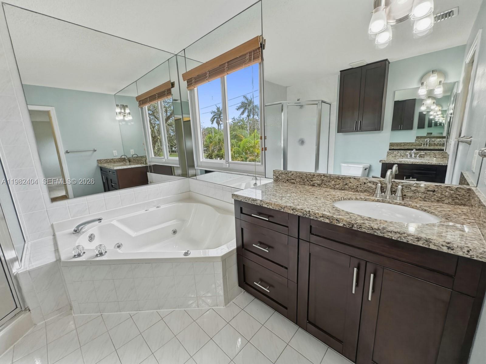 2640 Rampart Way North Cooper City, FL 33026 - Photo 28 of 58 a bathroom with a granite countertop bathtub sink vanity and mirror