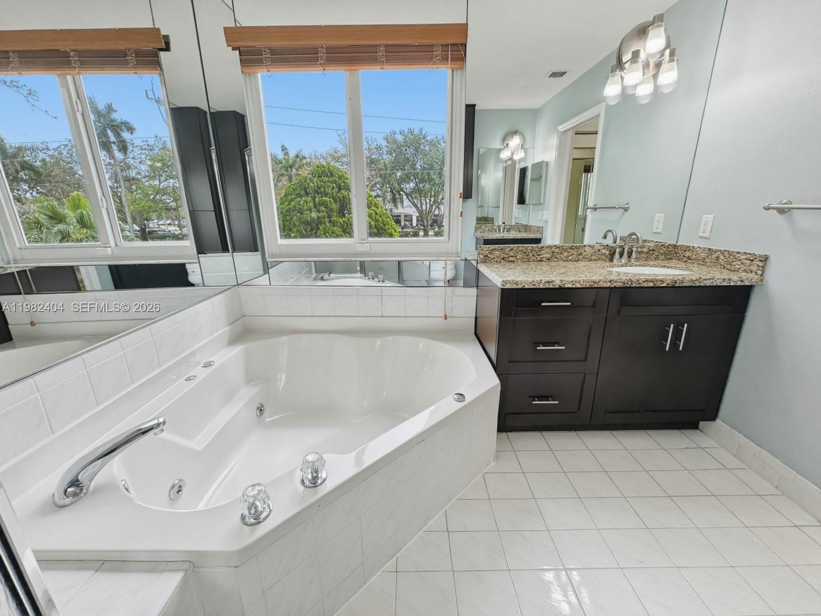 2640 Rampart Way North Cooper City, FL 33026 - Photo 29 of 58 a spacious bathroom with a tub sink and mirror