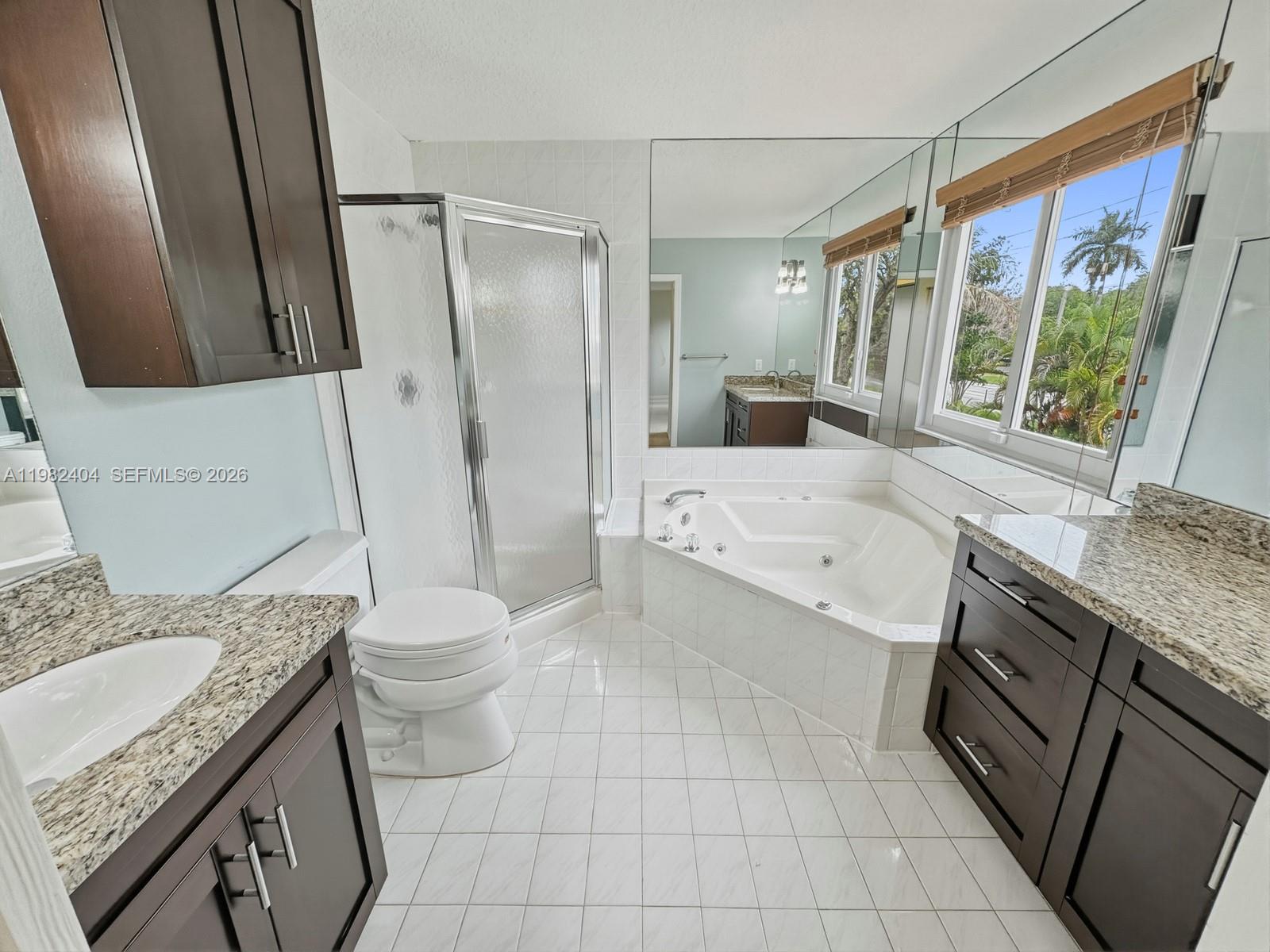 2640 Rampart Way North Cooper City, FL 33026 - Photo 30 of 58 a bathroom with a granite countertop sink toilet and shower