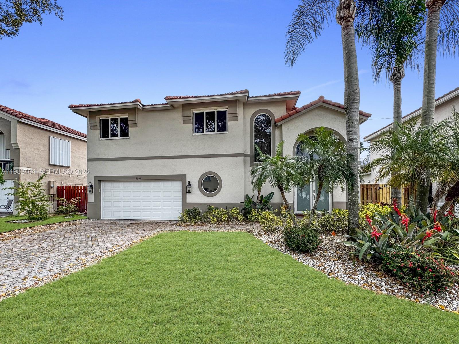 2640 Rampart Way North Cooper City, FL 33026 - Photo 3 of 58 a front view of a house with a garden and yard