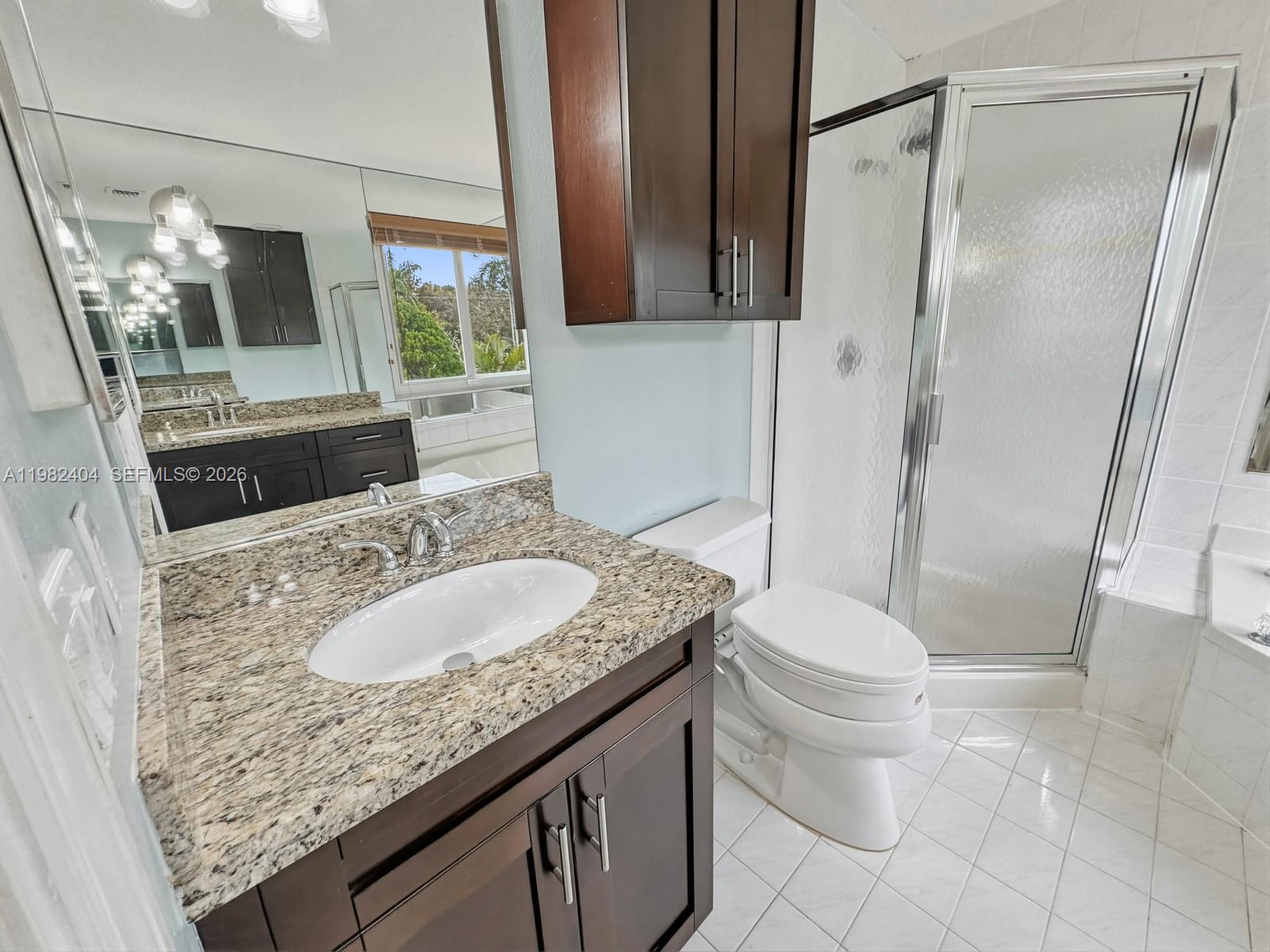 2640 Rampart Way North Cooper City, FL 33026 - Photo 31 of 58 a bathroom with a granite countertop sink toilet and shower