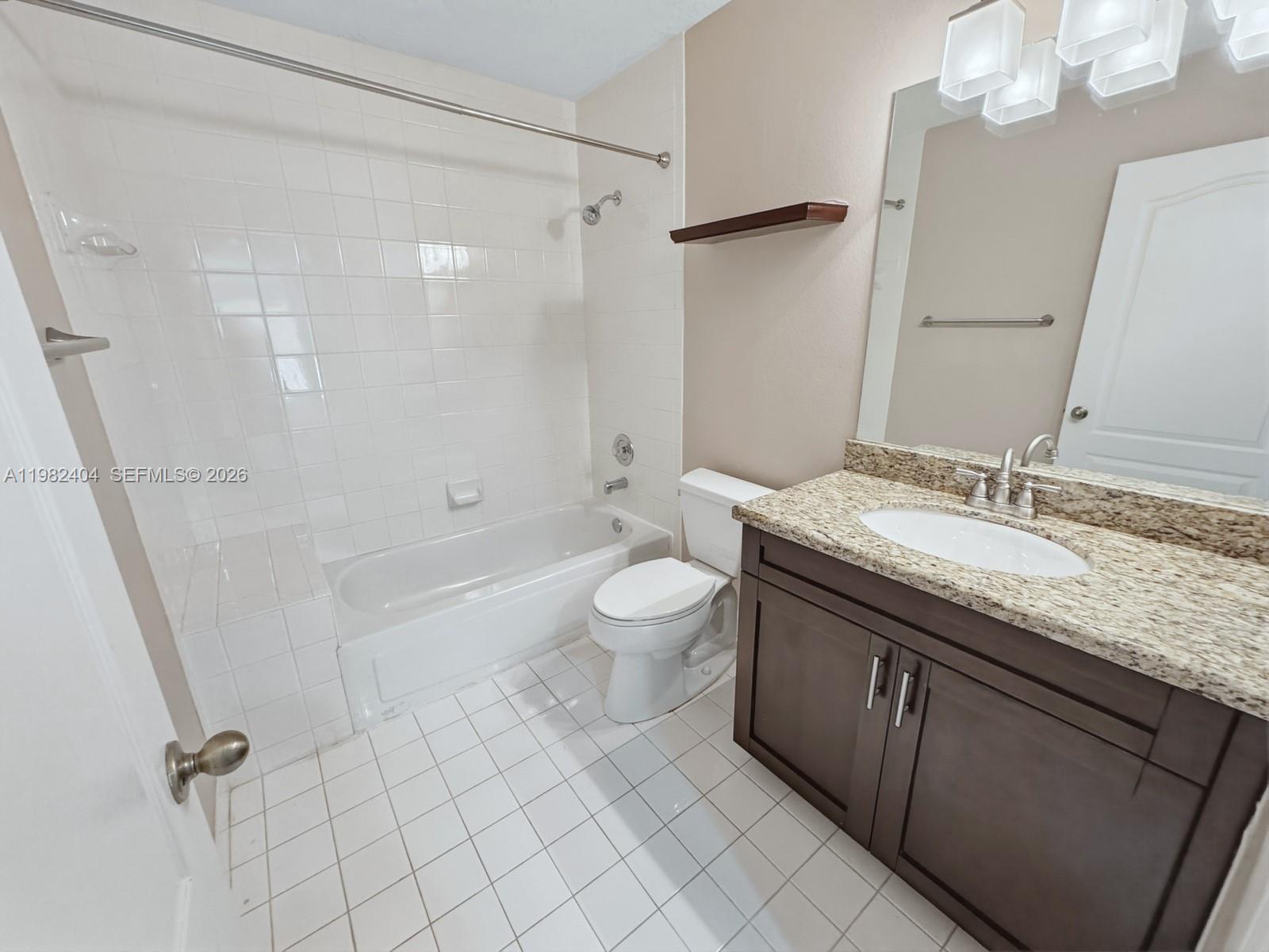 2640 Rampart Way North Cooper City, FL 33026 - Photo 33 of 58 a bathroom with a granite countertop sink a toilet a mirror and shower
