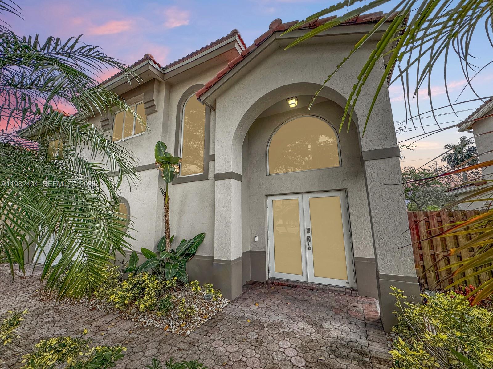 2640 Rampart Way North Cooper City, FL 33026 - Photo 4 of 58 a front view of a house with garden