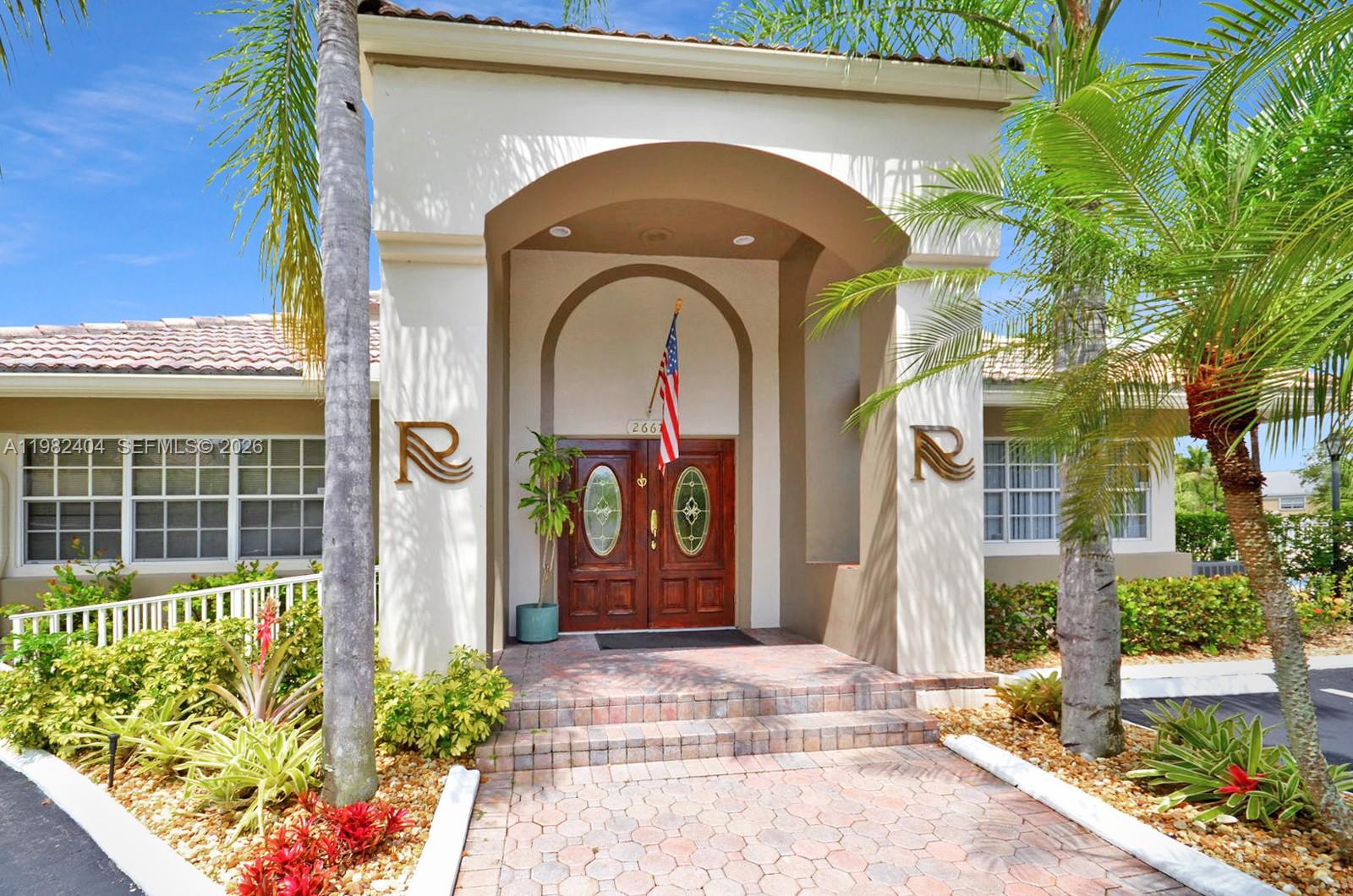 2640 Rampart Way North Cooper City, FL 33026 - Photo 48 of 58 a front view of a house with a garden