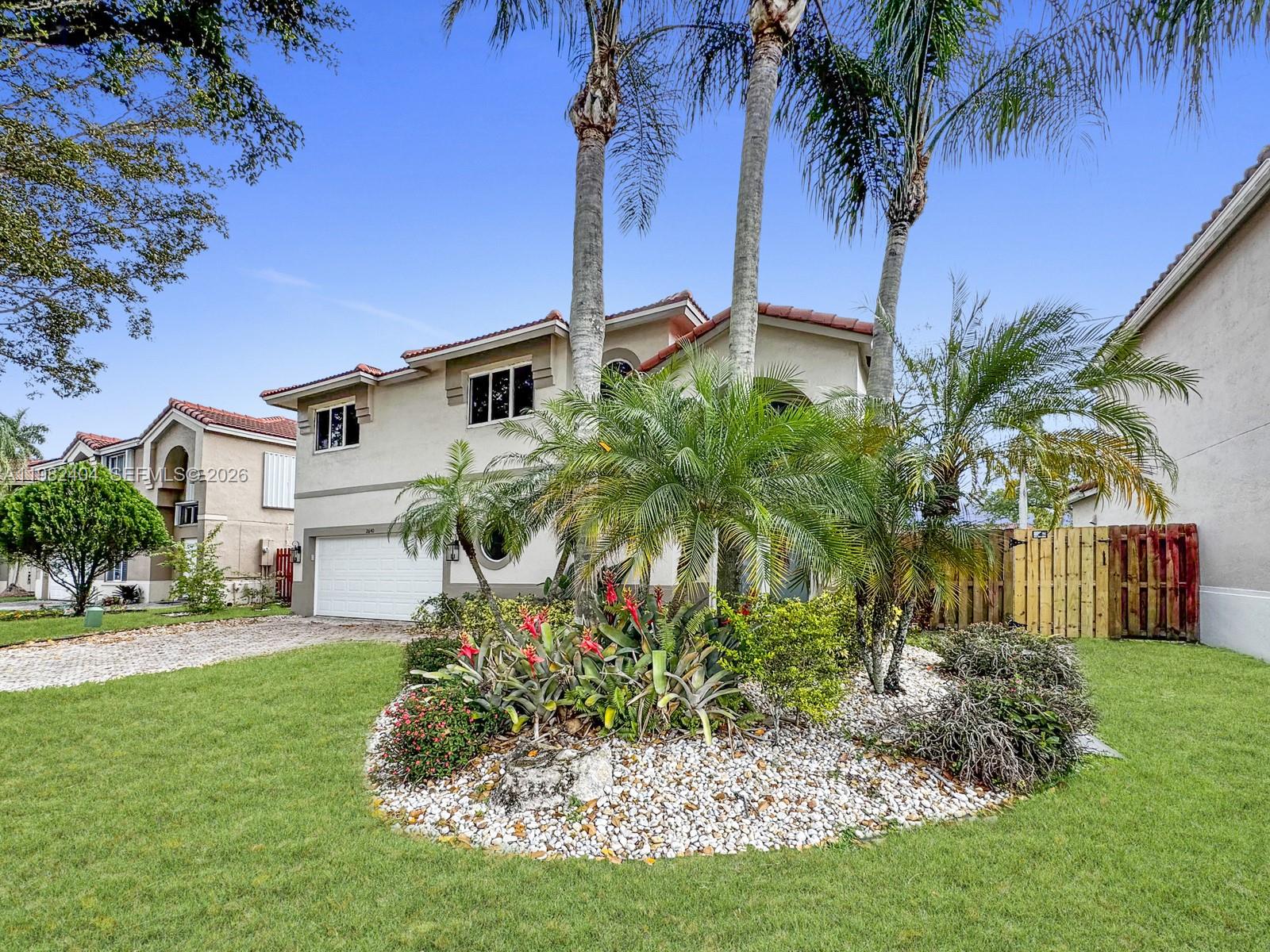 2640 Rampart Way North Cooper City, FL 33026 - Photo 5 of 58 a front view of a house with garden