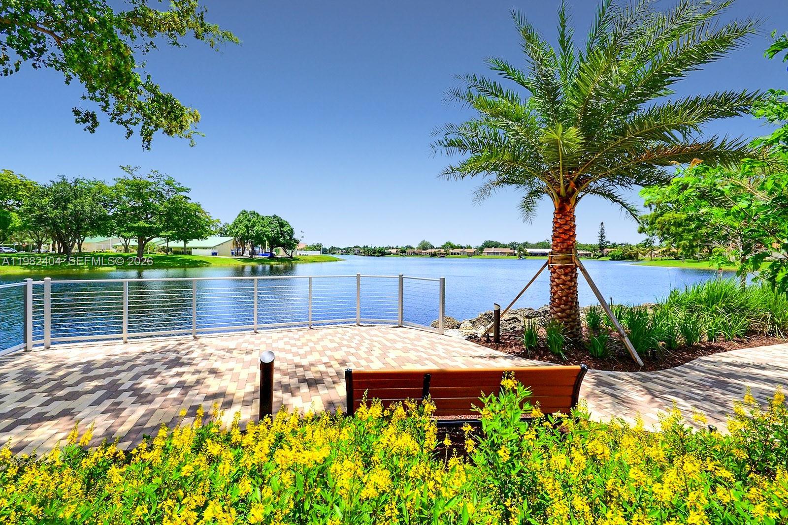 2640 Rampart Way North Cooper City, FL 33026 - Photo 54 of 58 a view of a lake with a sitting space and a lake view