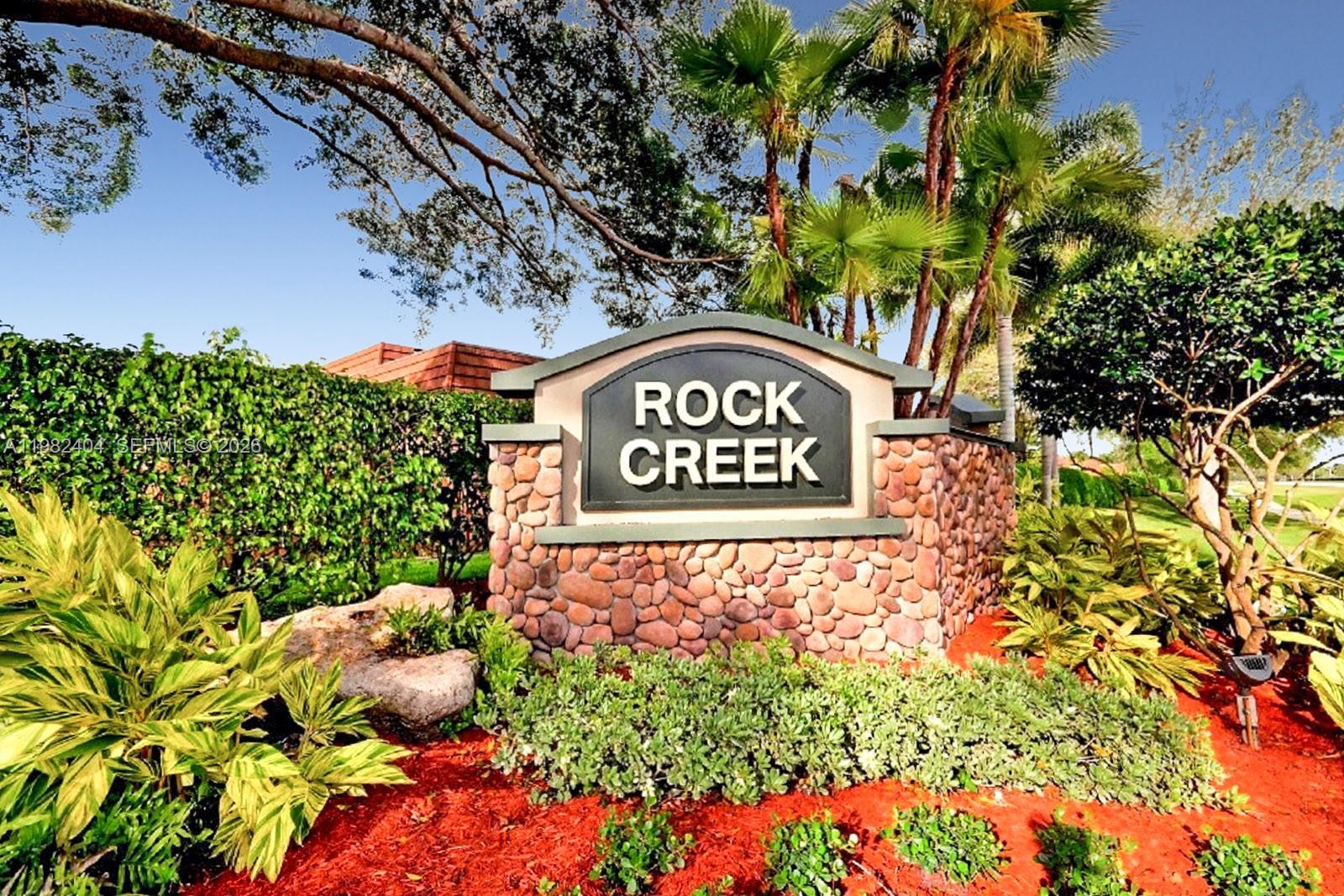 2640 Rampart Way North Cooper City, FL 33026 - Photo 58 of 58 a sign that is sitting in front of flowers